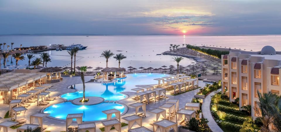 Dream at dusk as the lagoon pool lights up seaside.