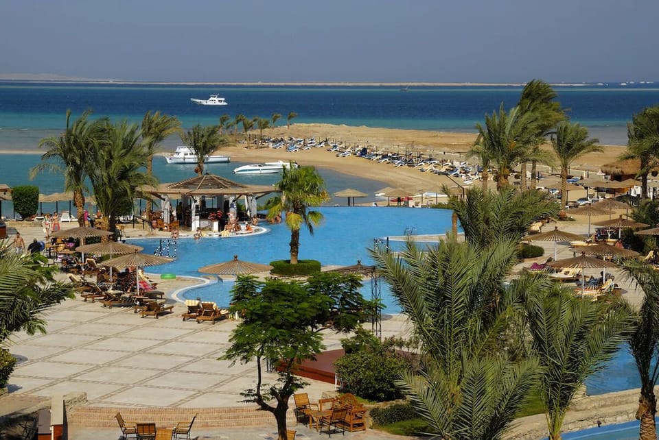 Feel the resort buzz with pools, palms, and beach steps away.