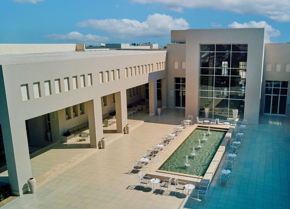 Unwind poolside in a serene courtyard with sleek seating.