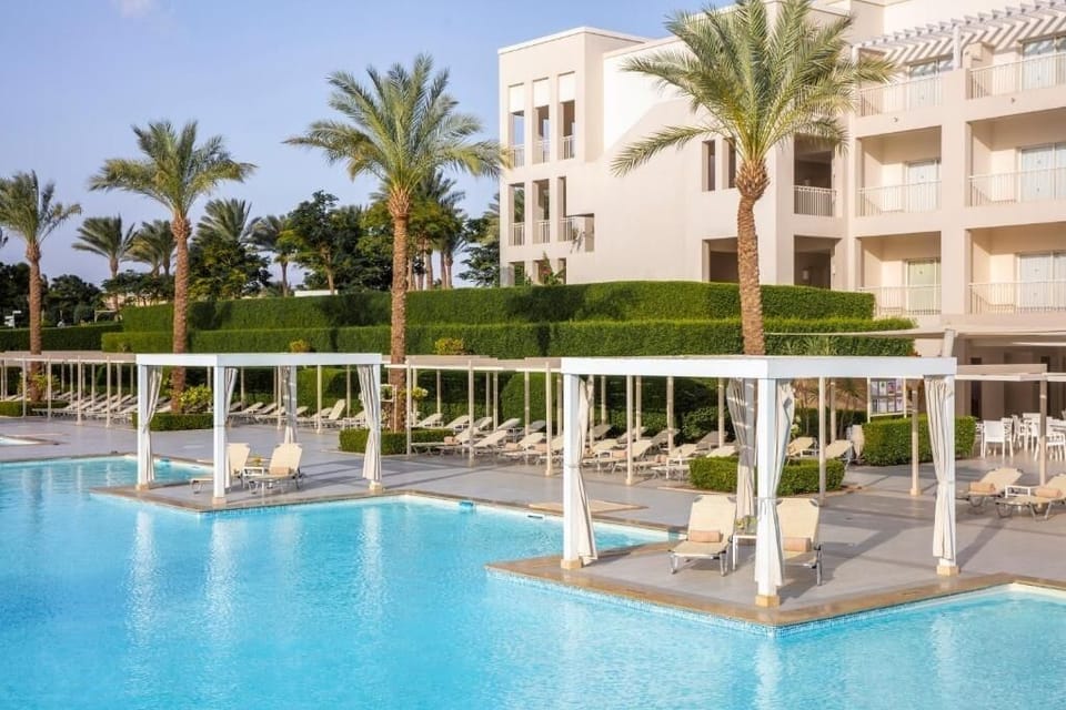 Dive into sparkling resort pools framed by palms and cabanas.