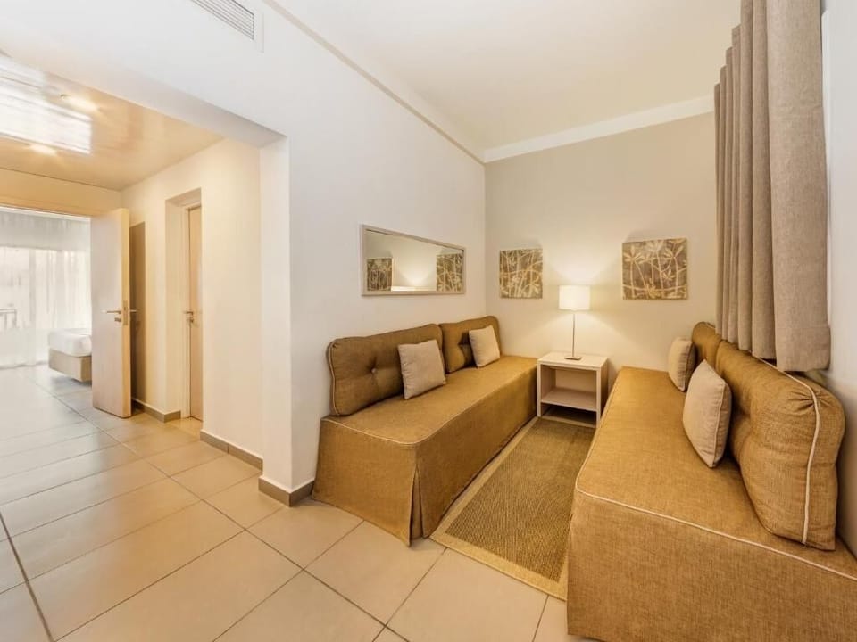 Unwind on spacious sofas after a beach-and-pool day.