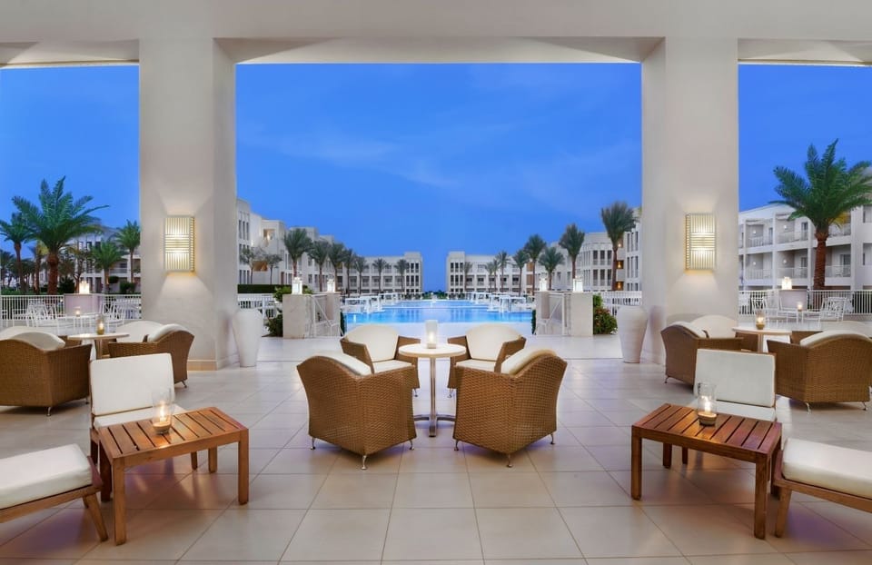 Breathe in sunset air overlooking the shimmering pool courtyard.