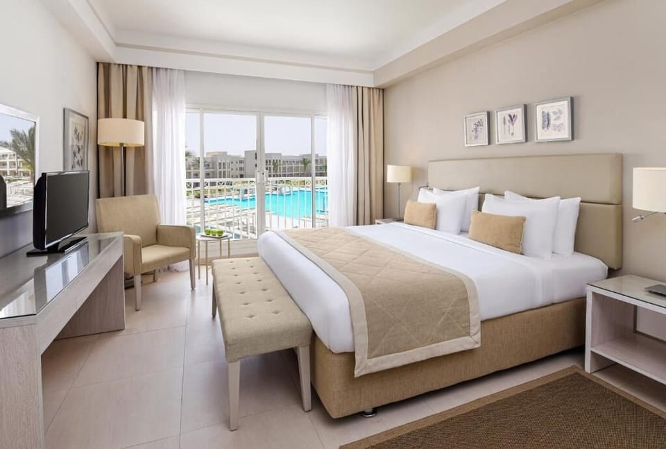 Stretch out in a plush king bed beside sunlit windows.