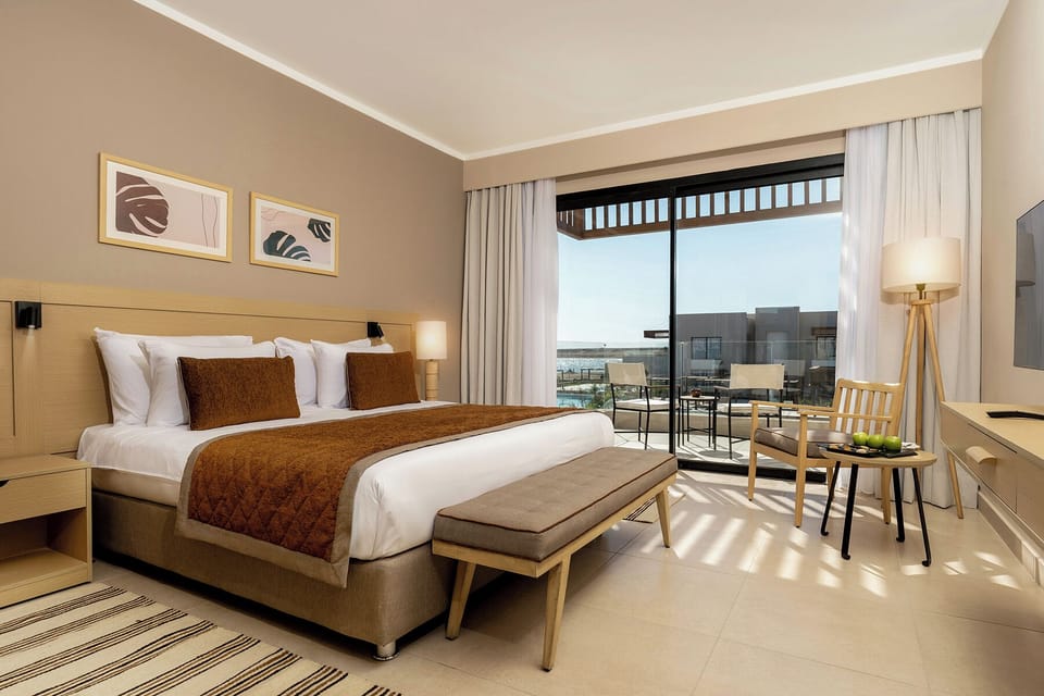 Wake up refreshed in a sunlit king room with balcony seating.