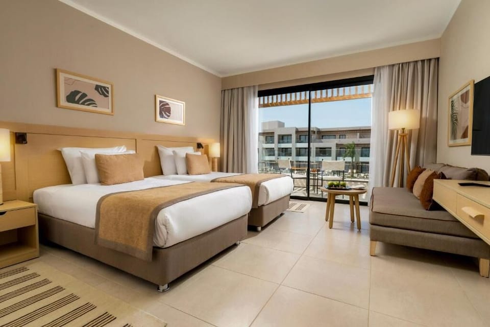 Relax in twin beds steps from your private balcony retreat.