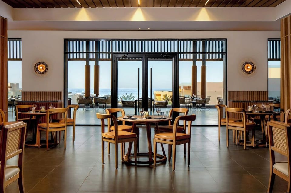 Dine with ocean breezes and sunset views through open doors.