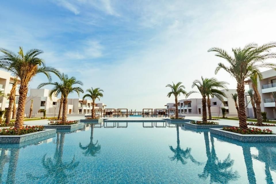 Float into calm mornings with mirror-blue water and palms.