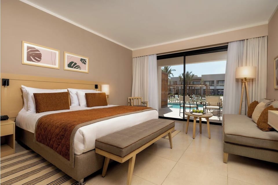 Stretch out in a calm bedroom with poolside patio access.