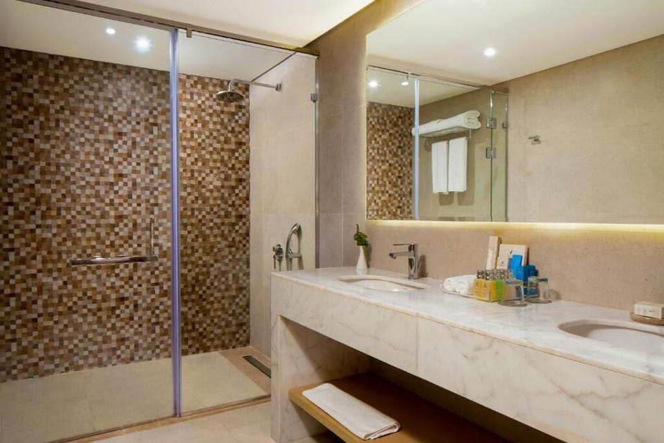 Refresh under a rainfall shower in a spa-like bathroom.