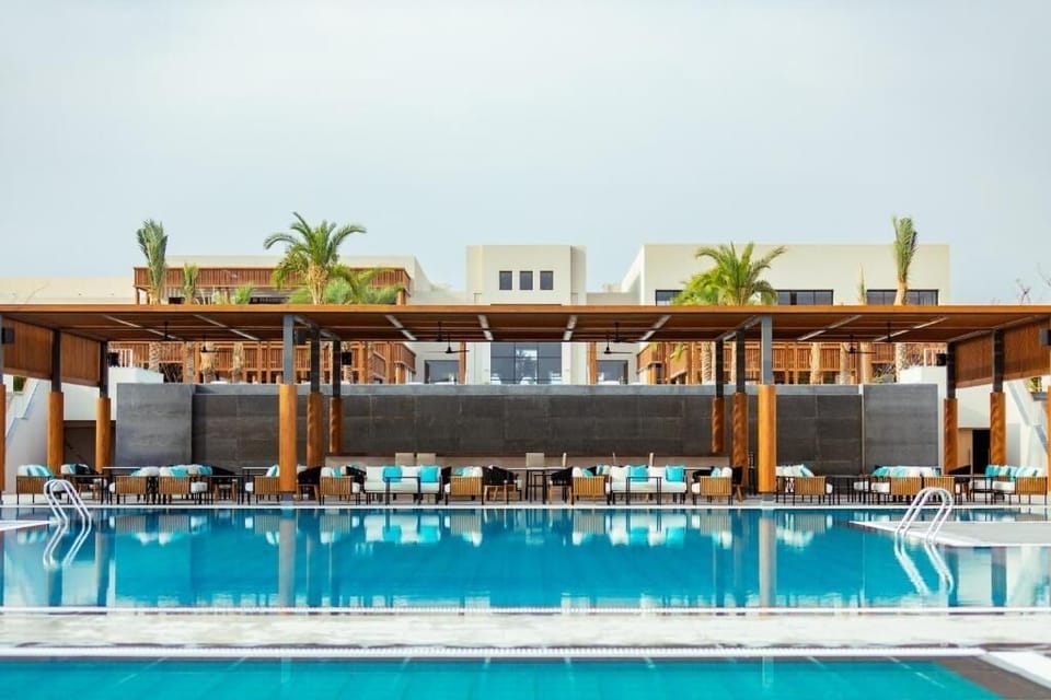 Linger poolside with chic loungers and breezy shaded seating.
