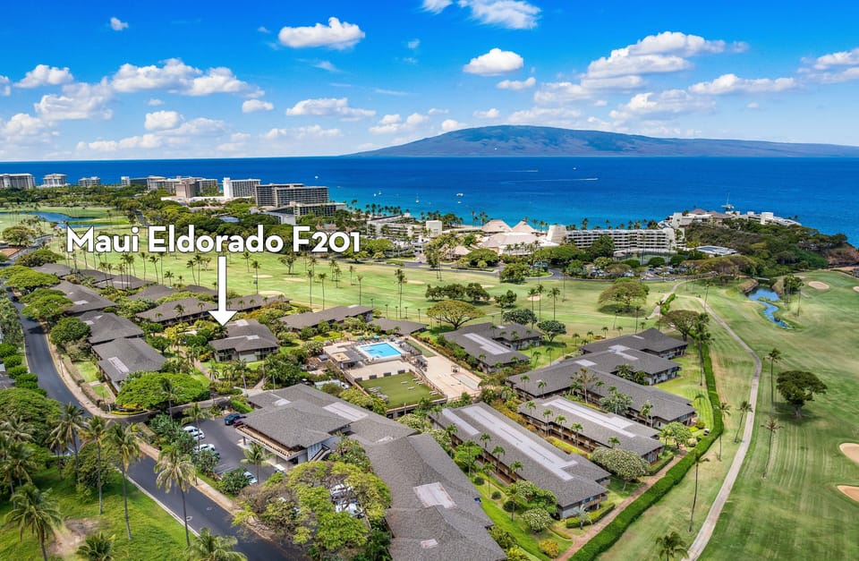 Aerial view of Maui Eldorado framed by lush golf course greens and shimmering ocean views