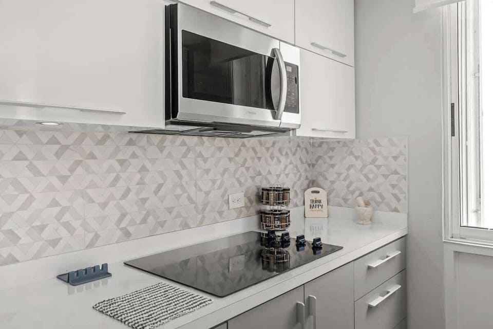Your convenient culinary corner! This bright kitchenette area features a microwave and ample counter space, perfect for preparing quick meals or snacks during your stay.