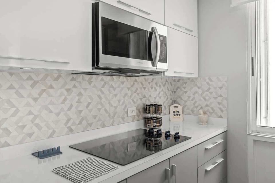 Your convenient culinary corner! This bright kitchenette area features a microwave and ample counter space, perfect for preparing quick meals or snacks during your stay.