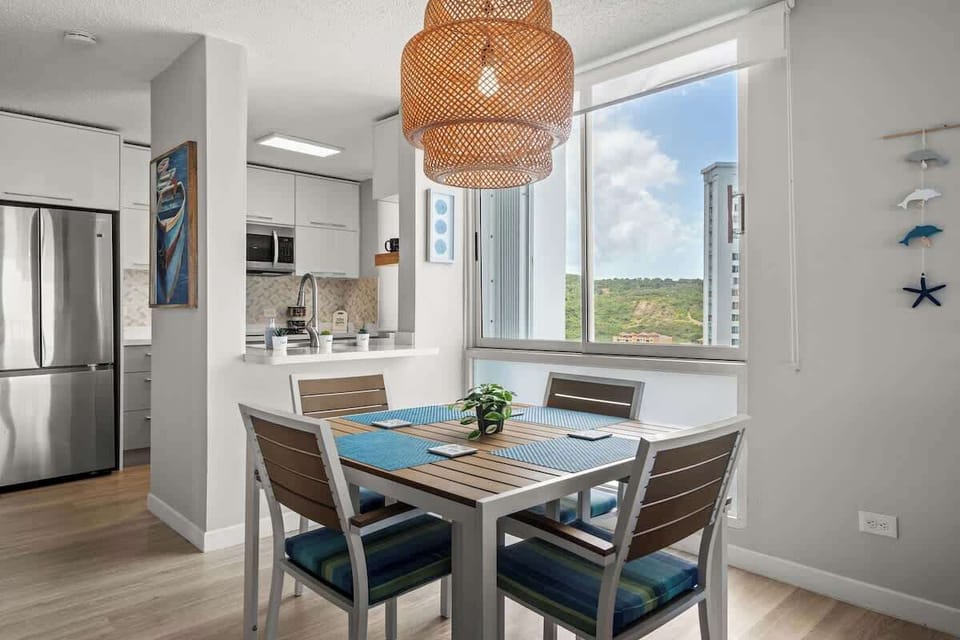 "Dine with a view! This elegant dining area offers comfortable seating for four, with direct access to a private balcony, perfect for enjoying meals with a refreshing breeze and scenic vistas.