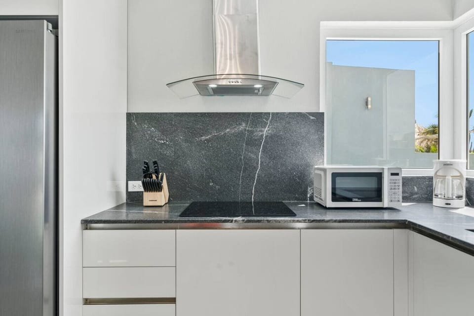 Sleek kitchen counter with modern finish and cooking essentials.