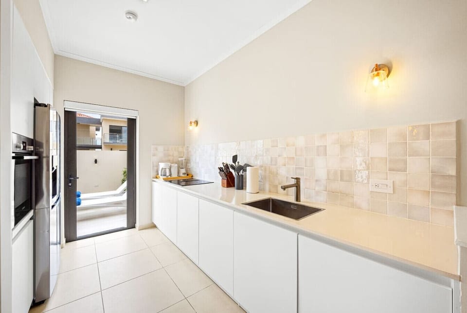 Functional layout with long counter, backyard access, and full appliances.