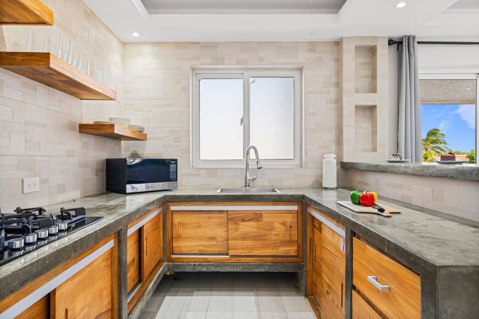 Kitchen with sink, microwave and window light
