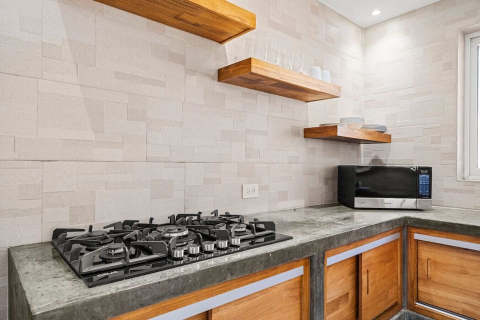 Kitchen with stove, oven and open shelving