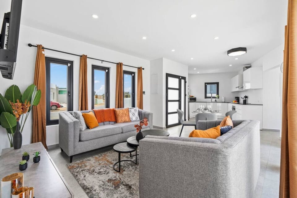 Relax in a chic living room with bold, vibrant designer touches.