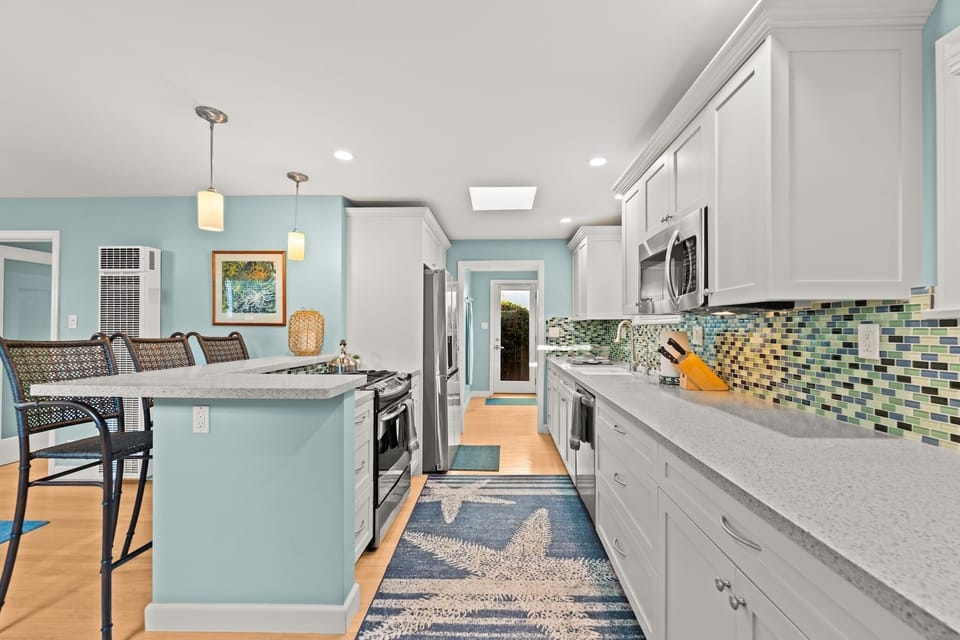 Coffee or cocktails? This kitchen island offers the perfect bar seating for three, making it the instant social hub of the home.