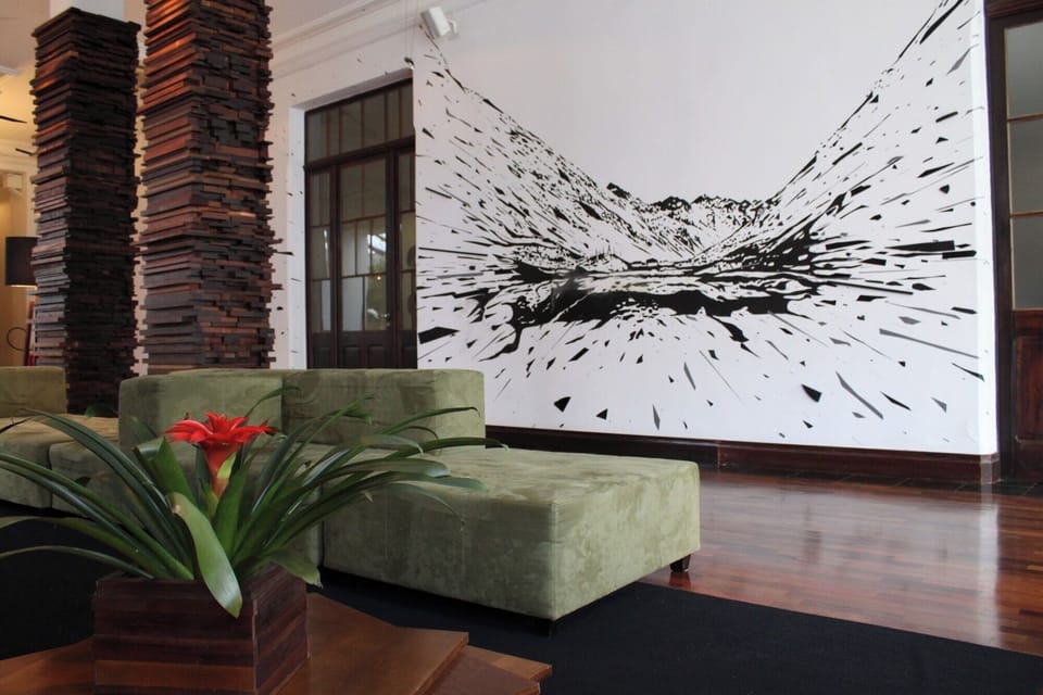 Sink into plush lounge seating beneath striking gallery-style mural.