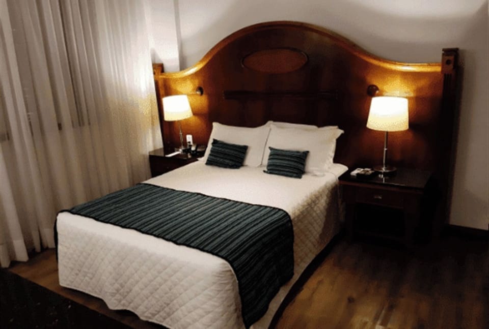 Drift off under warm bedside lighting and plush, inviting pillows.