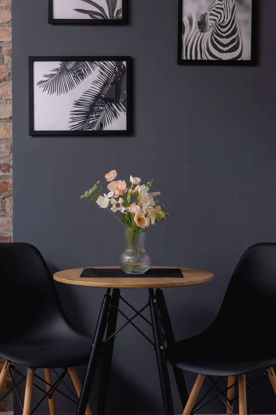 A small table with flowers and two chairs creates an intimate spot for a morning coffee or a romantic dinner.