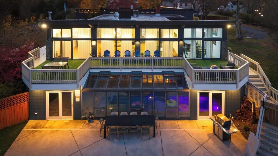 Evening-ready outdoor area with cozy lighting, lounging, and grilling space.