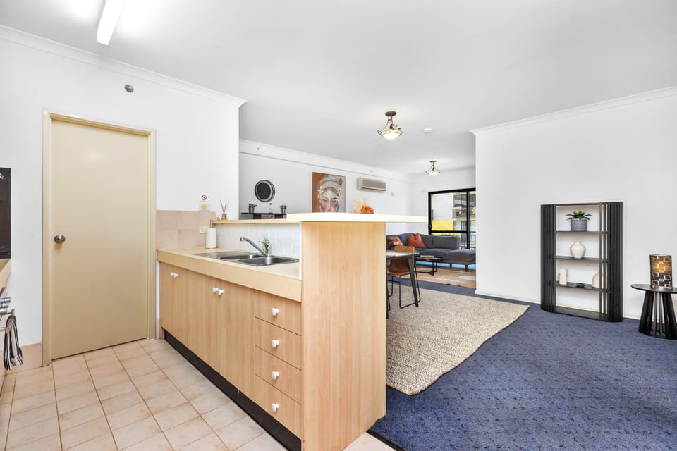 Kitchen has a view of the dining and living spaces, perfect for family time.