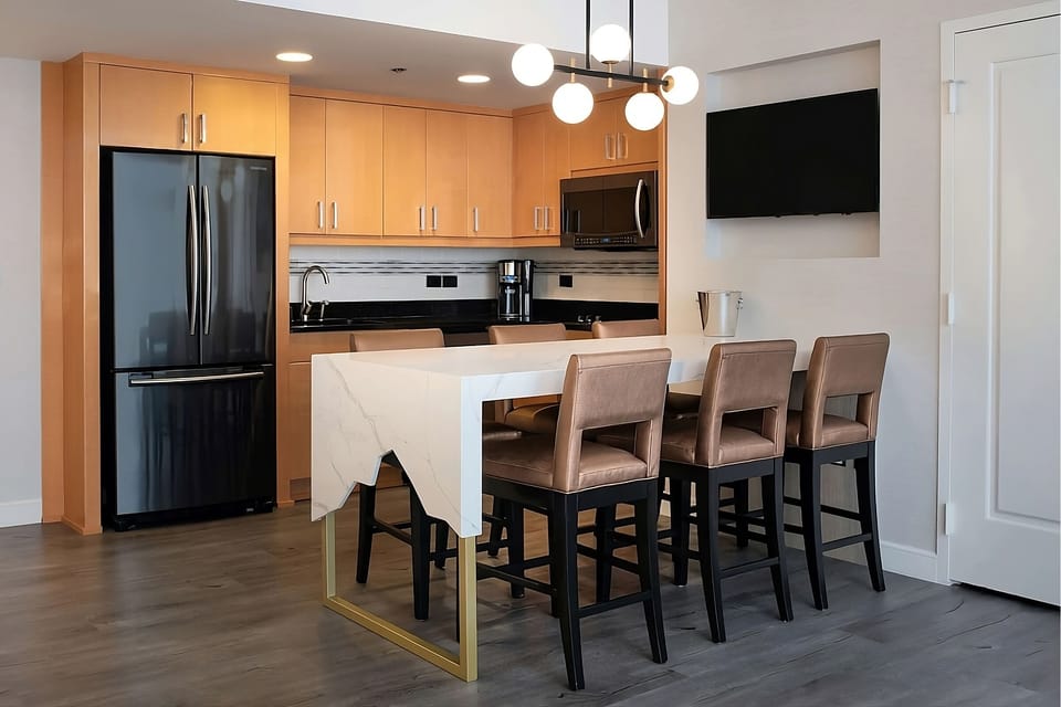 Cook and connect around the sleek island with bar seating.