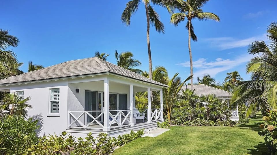 Arrive at your private cottage wrapped in swaying palms.