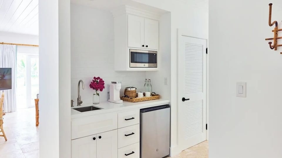 Brew morning coffee easily in this crisp, modern kitchenette.
