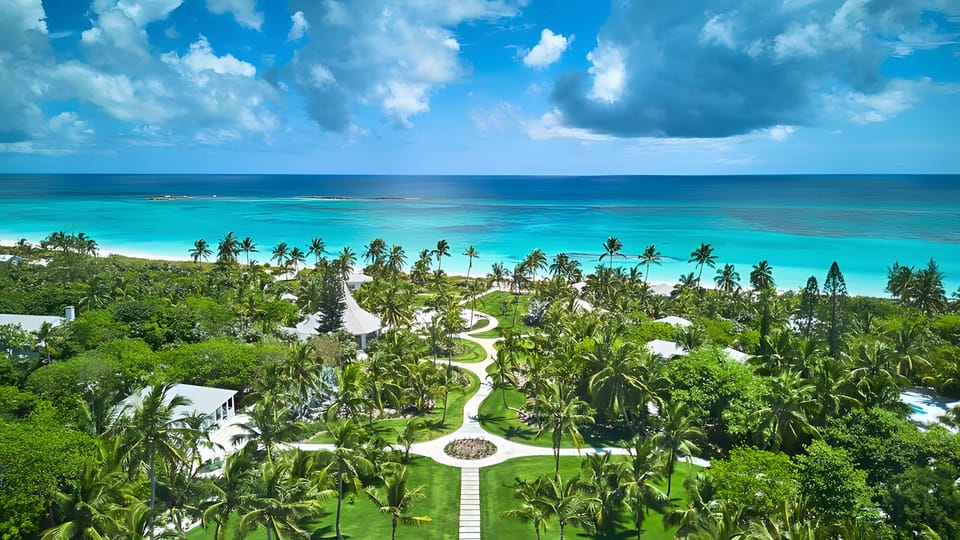 Soar above lush gardens to endless turquoise sea views.