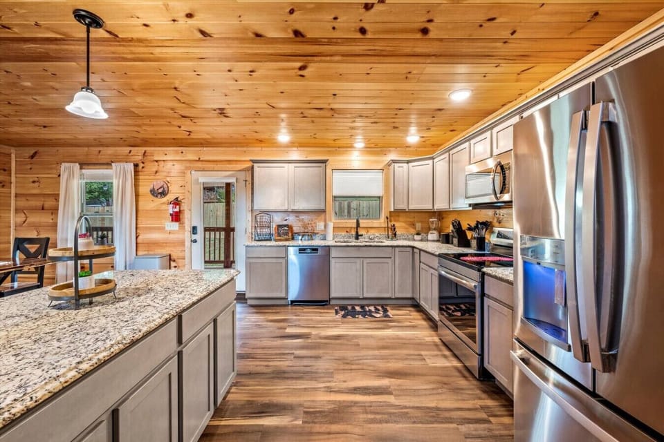 Spacious kitchen with stainless appliances, granite counters, and room to gather. Perfect for cooking meals, sipping morning coffee, and spending time together before heading out to explore.