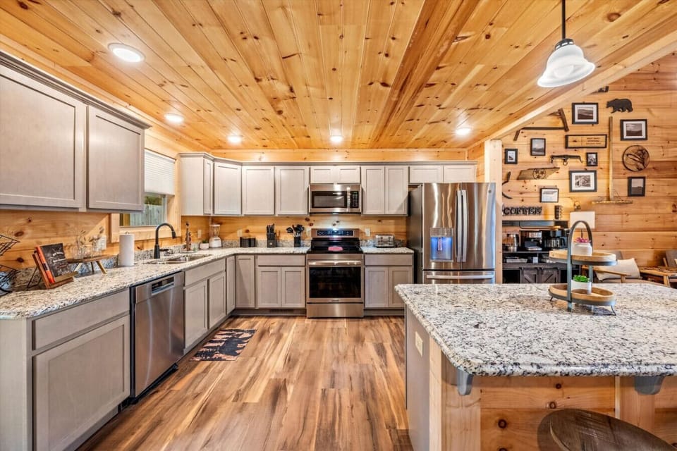 The heart of the home, this fully equipped kitchen features granite countertops, stainless appliances, and warm wood finishes. Cook up big breakfasts or family dinners with ease in this open, inviting space.