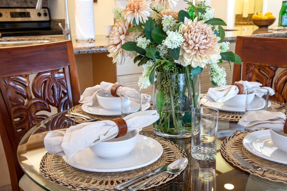  Gather around carved wood chairs and floral centerpieces in a dining space that flows gracefully toward the view    WH1-615
