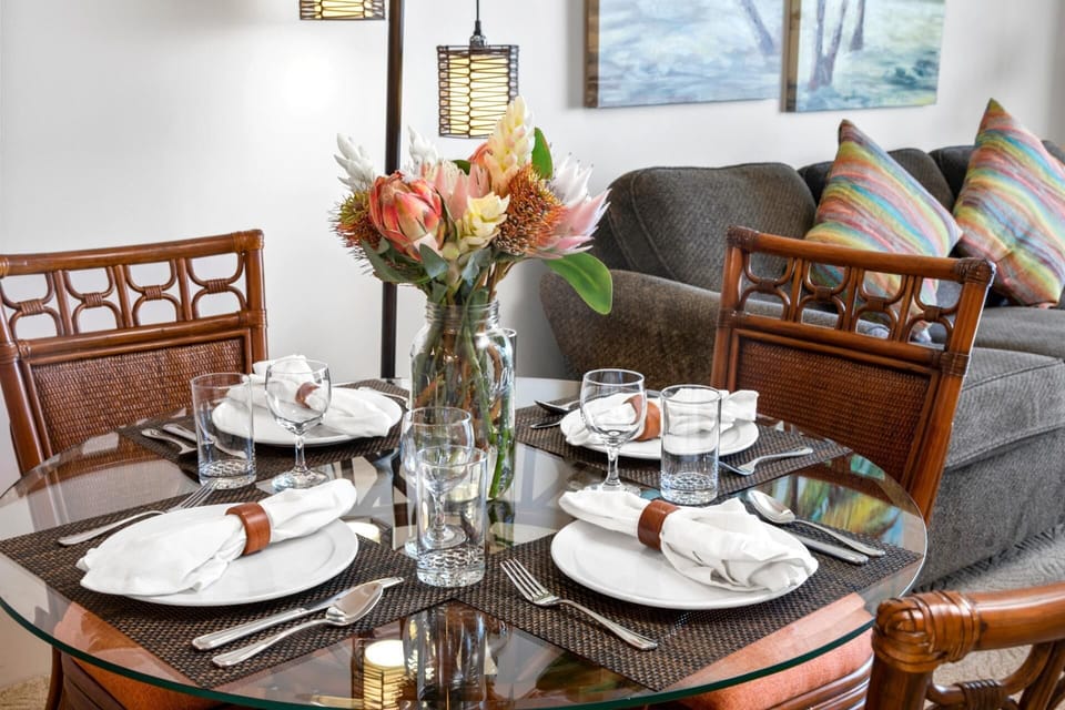   Dine in style with rich wood textures, soft neutral tones, and a floral centerpiece that adds an organic island touch  WH1-1211