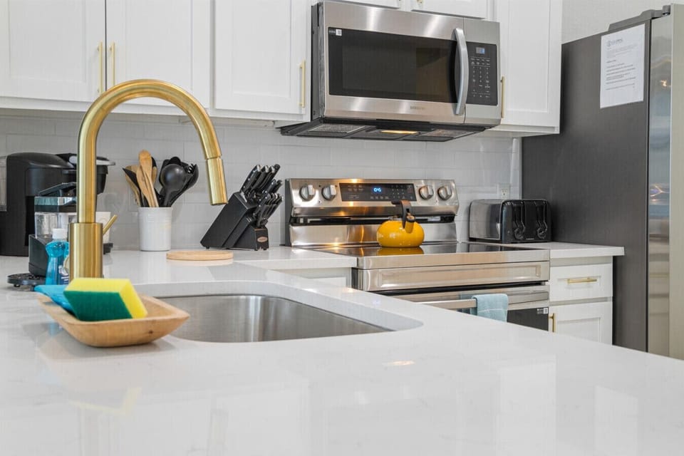 Cook with ease in the fully equipped modern kitchen featuring stainless steel appliances, counter space, and utensils that you need for family favorites or quick snacks