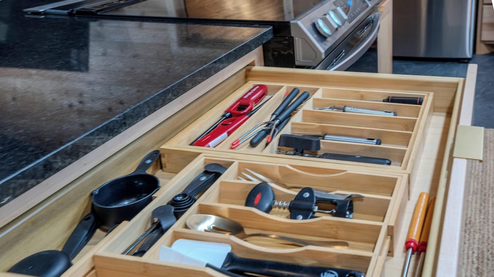 Fully stocked kitchen drawers with cooking tools and essentials provided