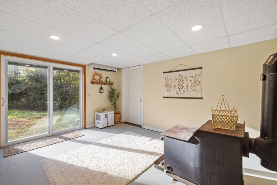 Bright walkout level with sunlight, decor, and access to the outdoors.