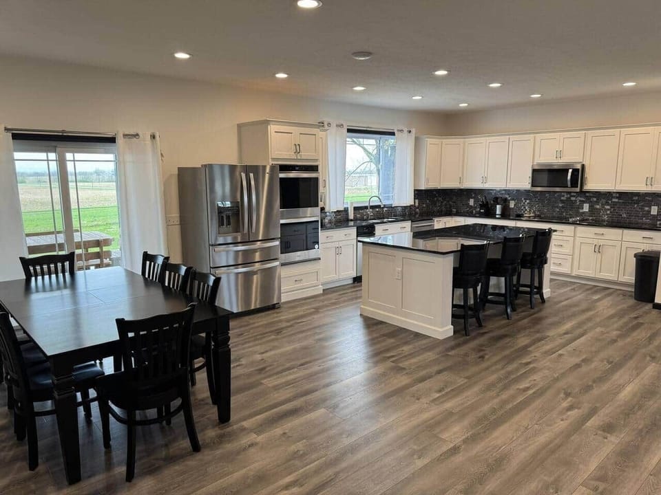 You'll enjoy our fully stocked upstairs kitchen with Amish-built cabinets, island with stools, large refrigerator, double oven, large microwave, and large dinner table!