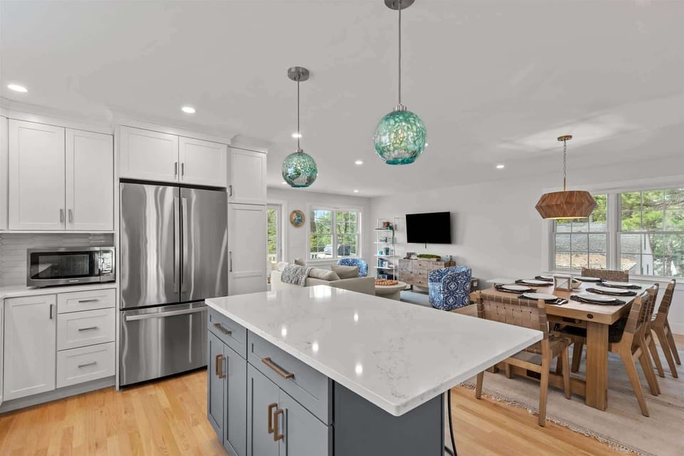Modern kitchen featuring quartz countertops and crisp coastal cabinetry.