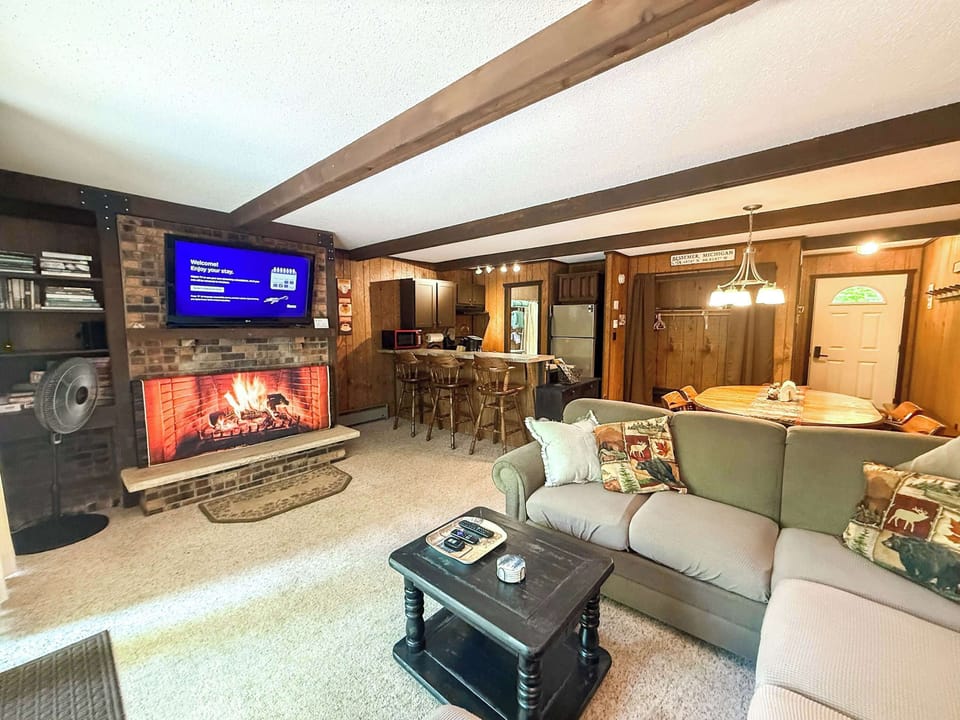 Lodge-Style Living Room – Comfortable sectional, TV,  Roku, and cabin décor.