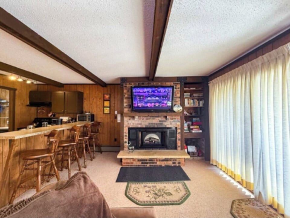 Cozy nights at Cabin Fevers with Roku TV and glow of electric fireplace.
