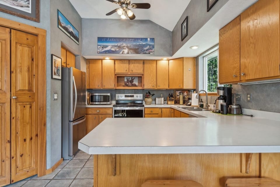 A fully stocked kitchen to provide ease while on vacation. | Upper Level