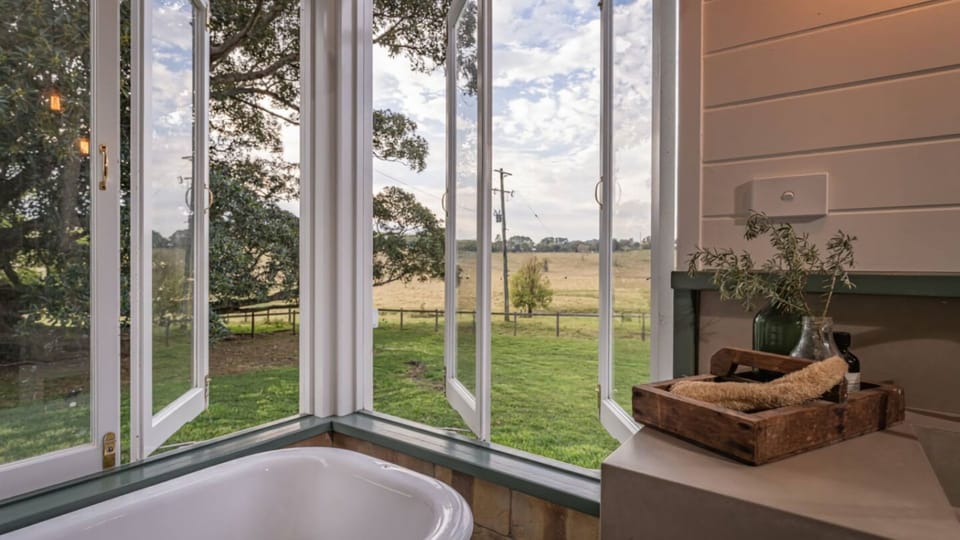 Bathroom window framing open paddock views.