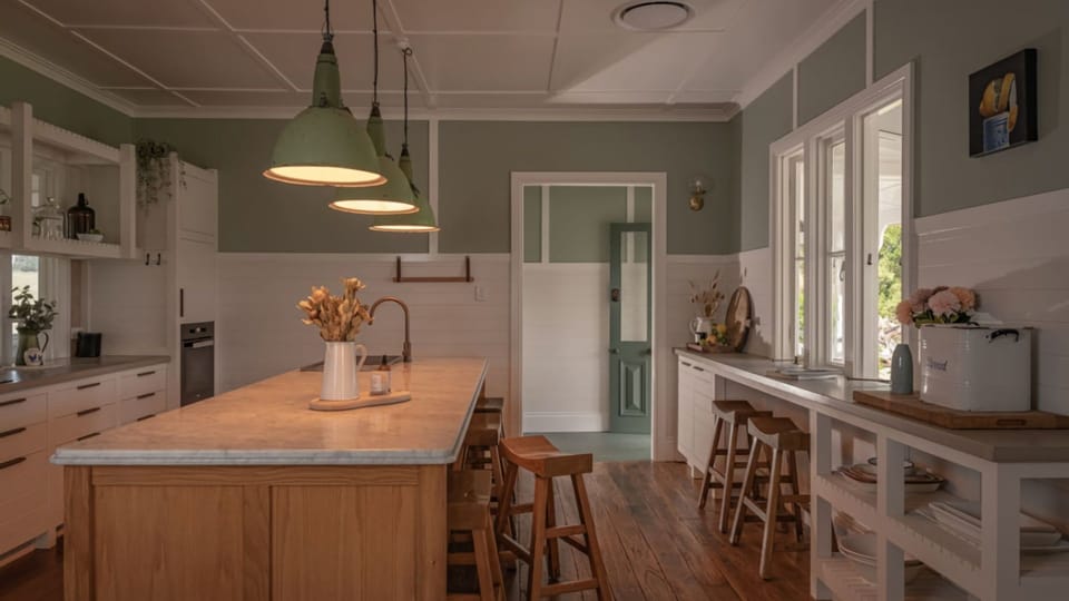 Bright farmhouse kitchen with large island and open layout.