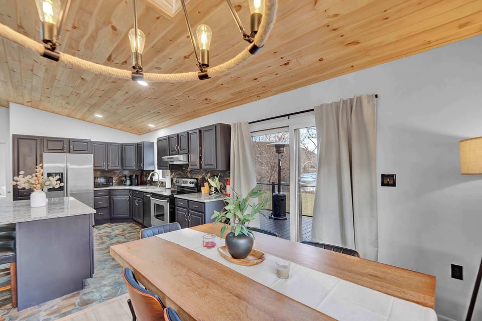 Dining Area with Chandelier and Open Kitchen Layout