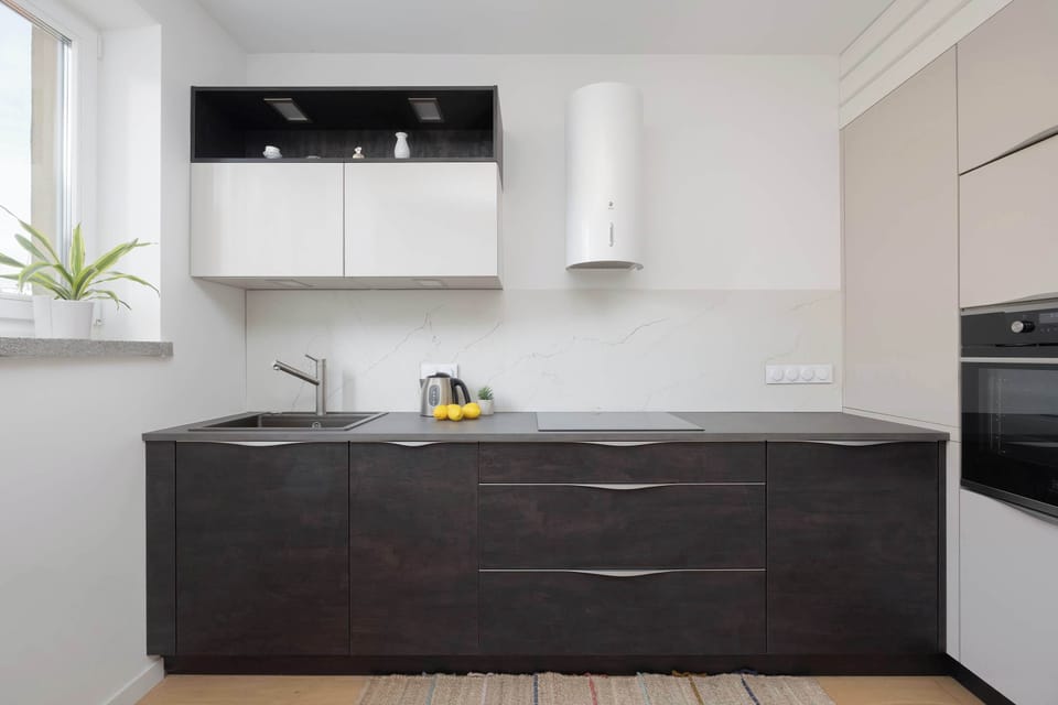 The kitchen, equipped with state-of-the-art appliances, becomes a bright and welcoming space for culinary creativity.