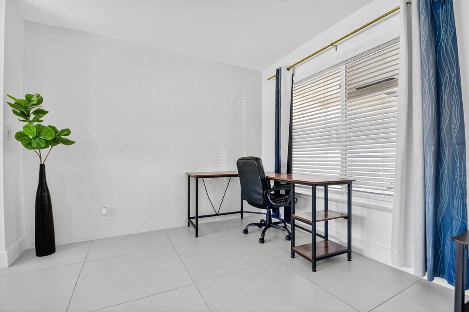 Open bright living area with Smart TV and work space 